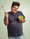 Studio, portrait and overweight man with salad for weight loss, diet and healthy meal with nutrition. Obese, male person Royalty Free Stock Photo