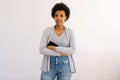 Studio portrait of pensive African American woman student holding pen and copybook to study for exam wants to enter Royalty Free Stock Photo