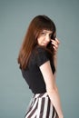 Studio portrait of a young woman against plain black background