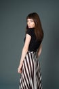 Studio portrait of a young woman against plain black background