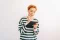 Studio portrait of pretty young woman writing down in notebook diary remind memories and make list of dreams standing on Royalty Free Stock Photo