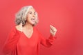 Excited mature woman celebrating while raising the fists Royalty Free Stock Photo