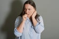 Studio portrait of scared woman biting her nails Royalty Free Stock Photo