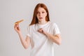 Studio portrait of scared young woman suffering from choking and cough after eating pizza, beats her chest standing on Royalty Free Stock Photo