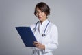 Smiling female doctor looking at camera and smiling while standing against at isolated background Royalty Free Stock Photo