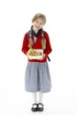 Studio Portrait of Smiling Girl Holding Lunchbox