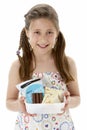 Studio Portrait of Smiling Girl Holding Lunchbox Royalty Free Stock Photo