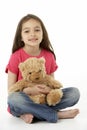 Studio Portrait Of Smiling Girl with Teddy Bear Royalty Free Stock Photo