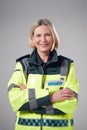 Studio Portrait Of Smiling Mature Female Paramedic Against Plain Background Royalty Free Stock Photo