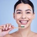 Studio portrait of a smiling mixed race young woman with glowing skin posing against blue copyspace background while Royalty Free Stock Photo