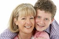 Studio Portrait of Smiling Teenage Boy with Mum Royalty Free Stock Photo