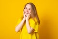 Portrait of a smiling teenage girl on a yellow background Royalty Free Stock Photo