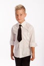 Studio portrait of stylish caucasian blond boy in shirt and tie, white background, copy space Royalty Free Stock Photo