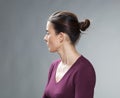 Studio portrait of a thinking 30s woman, profile view