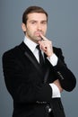 Studio portrait of thinking young business man. Royalty Free Stock Photo