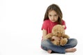 Studio Portrait Of Unhappy Girl with Teddy Bear