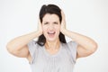 Studio Portrait Of Woman Covering Ears With Hands Royalty Free Stock Photo