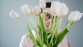 Studio Portrait of Young Adult Pretty Girl with Glasses Dressed in Pink T-shirt Holds Bouquet of Fresh Tulips Royalty Free Stock Photo