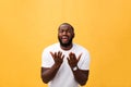 Studio portrait of young African American man in white shirt, holding hands in prayer, looking at the camera with Royalty Free Stock Photo