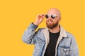 Studio portrait of a young bald bearded handsome man wearing cool sunglasses. Royalty Free Stock Photo