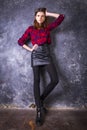 Studio portrait of young beautiful woman in a leather skirt. Royalty Free Stock Photo