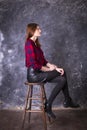 Studio portrait of young beautiful woman in a leather skirt Royalty Free Stock Photo