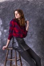 Studio portrait of young beautiful woman in a leather skirt Royalty Free Stock Photo