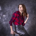 Studio portrait of young beautiful woman in a leather skirt Royalty Free Stock Photo