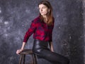 Studio portrait of young beautiful woman in a leather skirt Royalty Free Stock Photo