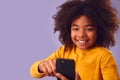 Studio Portrait Of Young Boy Using Mobile Phone Against Purple Background Royalty Free Stock Photo