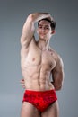 Studio portrait of a young brunette caucasian man on gray background posing. Puberty theme, problem skin, teen acne