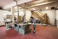 Studio portrait of a young carpenter while cutting a piece of wood with a circular saw Royalty Free Stock Photo