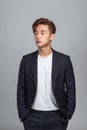 Studio portrait of a young East Asian man looking up