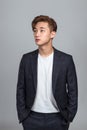 Studio portrait of a young East Asian man looking up