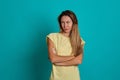 Studio portrait of a young fair-haired beautiful girl. Emotions of a girl on a blue background Royalty Free Stock Photo