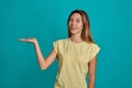 Studio portrait of a young fair-haired beautiful girl. Emotions of a girl on a blue background Royalty Free Stock Photo