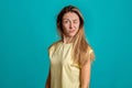 Studio portrait of a young fair-haired beautiful girl. Emotions of a girl on a blue background Royalty Free Stock Photo