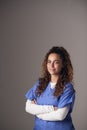 Studio Portrait Of Young Female Nurse Wearing Scrubs Standing Against Grey Background Royalty Free Stock Photo