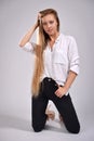 Young blond girl with long hair in a white shirt