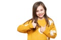 Studio portrait of a young girl on white background giving thumbs up while smiling and looking at camera. Ok sign. Royalty Free Stock Photo