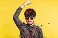 Studio portrait of a young man in love with sunglasses on a yellow background. Royalty Free Stock Photo