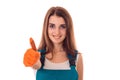 Studio portrait of young happy girl in uniform makes renavation and showing thumbs up isolated on white background