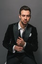 Studio portrait of a young man in a tuxedo against plain studio background Royalty Free Stock Photo