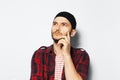 Studio portrait of young thoughtful man looking up on white background. Royalty Free Stock Photo