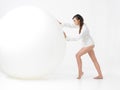 Studio portrait young woman big white balloon Royalty Free Stock Photo