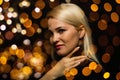 Studio portrait of young woman with dark skin, long curly hair, wearing sexy sequin dress santa claus hat, posing over Royalty Free Stock Photo