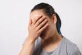 Studio portrait of a young woman, She puts her hand to her face in shame and frustration. The concept of failure and facepalm Royalty Free Stock Photo