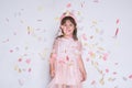 Studio portrtait of cute little girl wearing pink dress in tulle with princess crown on head on white background enjoy Royalty Free Stock Photo