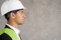 Studio profile portrait of young arabic man architect, builder engineer, wearing white construction safety helmet Royalty Free Stock Photo