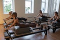Studio reformer class dynamics, energetic group pilates reformer session with focused movement Royalty Free Stock Photo